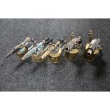 A collection of five antique brass blow lamps