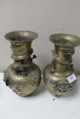 A pair of Chinese brass embossed vases