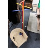 A multi coloured hat and coat stand together with a small child's chair