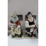 A pair of antique Staffordshire glazed pottery figures a/f