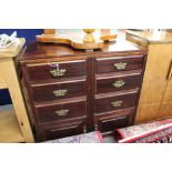 An Edwardian mahogany six drawer chest with cupboard base