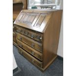 A carved oak bureau