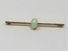 A yellow gold opal bar brooch