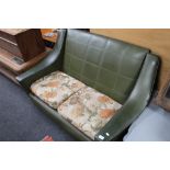 A mid century green vinyl two seater settee