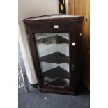 A nineteenth century oak glazed corner cabinet