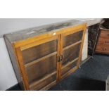 A glazed kitchen cabinet together with a further wooden bookcase