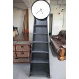 A wall clock with storage shelves beneath