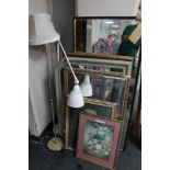 Two floor lamps together with pictures and mirrors