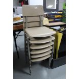 A stack of six mid century school chairs