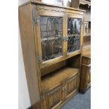 A carved oak display cabinet