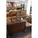 An early 20th century oak flap sided table and three chairs