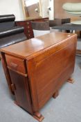 An early twentieth century oak storage dining table