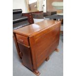 An early twentieth century oak storage dining table