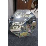 A frameless mirror with milk tray advertising
