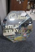 A frameless mirror with milk tray advertising