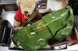 A tray of Harrods bag, teddy bear, hip flask,