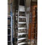 An aluminium ladder and wooden ladder