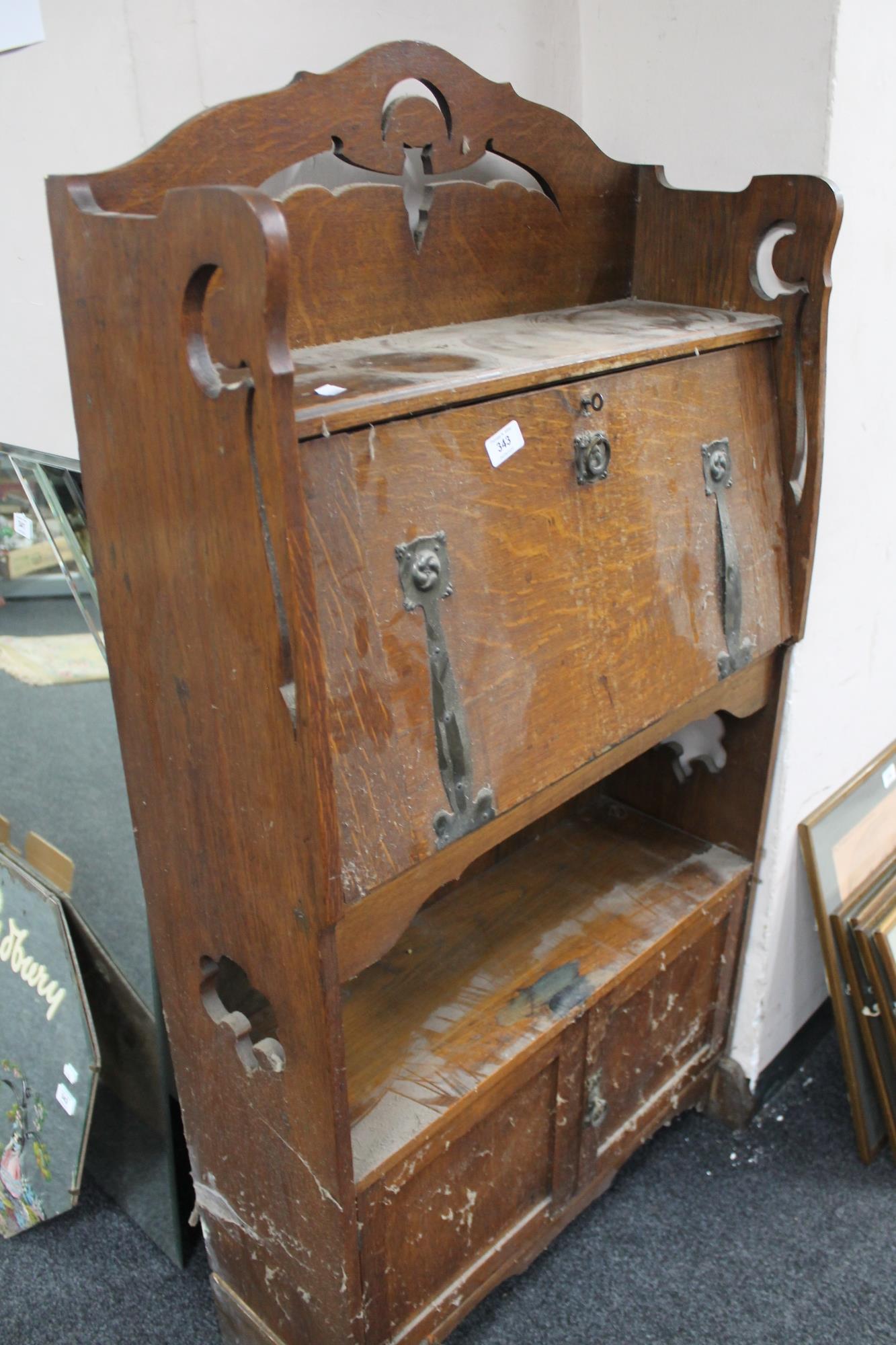 An early twentieth century fall front desk with carved bat motif CONDITION REPORT: