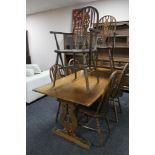 An oak refectory style dining room table together with a set of six Windsor style chairs
