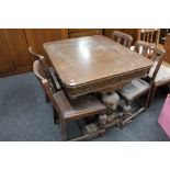 An early twentieth century carved oak table and four chairs