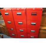 Three red metal four drawer filing chests