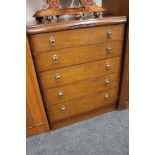 An early twentieth century oak five drawer chest