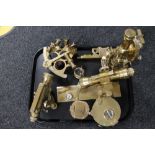 A collection of brass surveying instruments, compass, sextant,