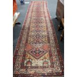 An antique Persian runner CONDITION REPORT: 487cm by 112cm.