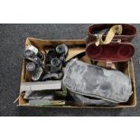 A box of binoculars, cameras,