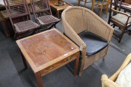 A wicker chair together with yewwood lamp table