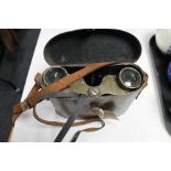A pair of antique brass binoculars in leather case