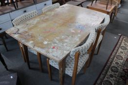 A mid century teak extending dining table and four chairs