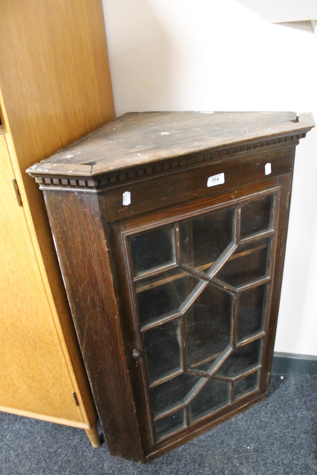 An Edwardian stained pine corner cabinet