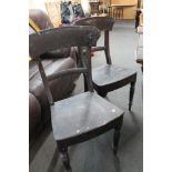 A pair of antique dining chairs