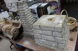 A concrete bird bath stand