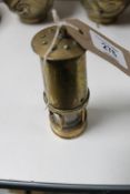 A miniature brass miner's lamp