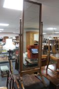 An Edwardian oak cheval mirror