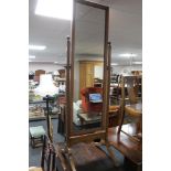 An Edwardian oak cheval mirror