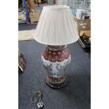 A Chinese table lamp on wooden stand