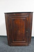 A George III oak hanging corner cabinet