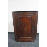 A George III oak hanging corner cabinet