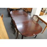 A mid century extending oval dining table and four chairs.