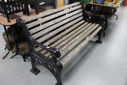 A heavy quality metal ended wooden slatted garden bench