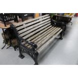 A heavy quality metal ended wooden slatted garden bench