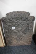 An antique cast iron fire back