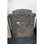 An antique cast iron fire back