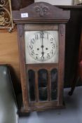 An Edwardian stained beech wall clock