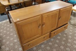 An Ercol elm sideboard