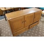 An Ercol elm sideboard