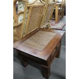 A cane topped lamp table fitted with a drawer